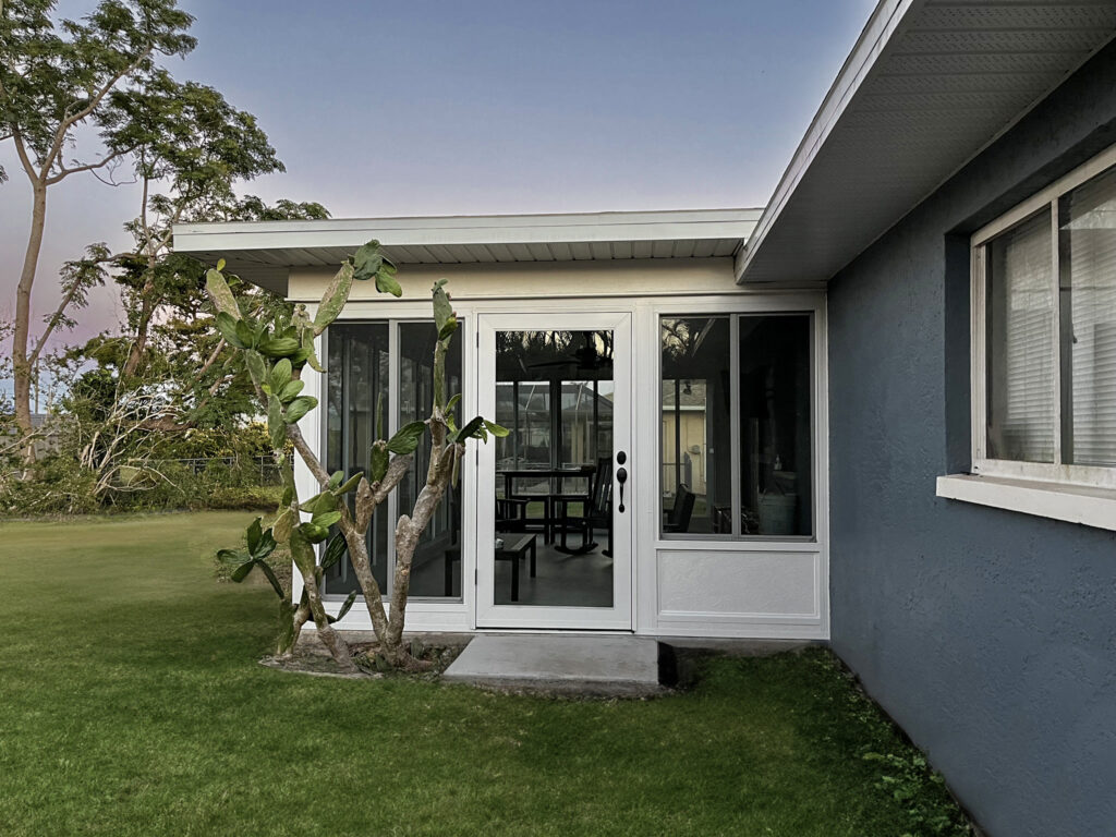 Small cozy sunroom framed by greenery